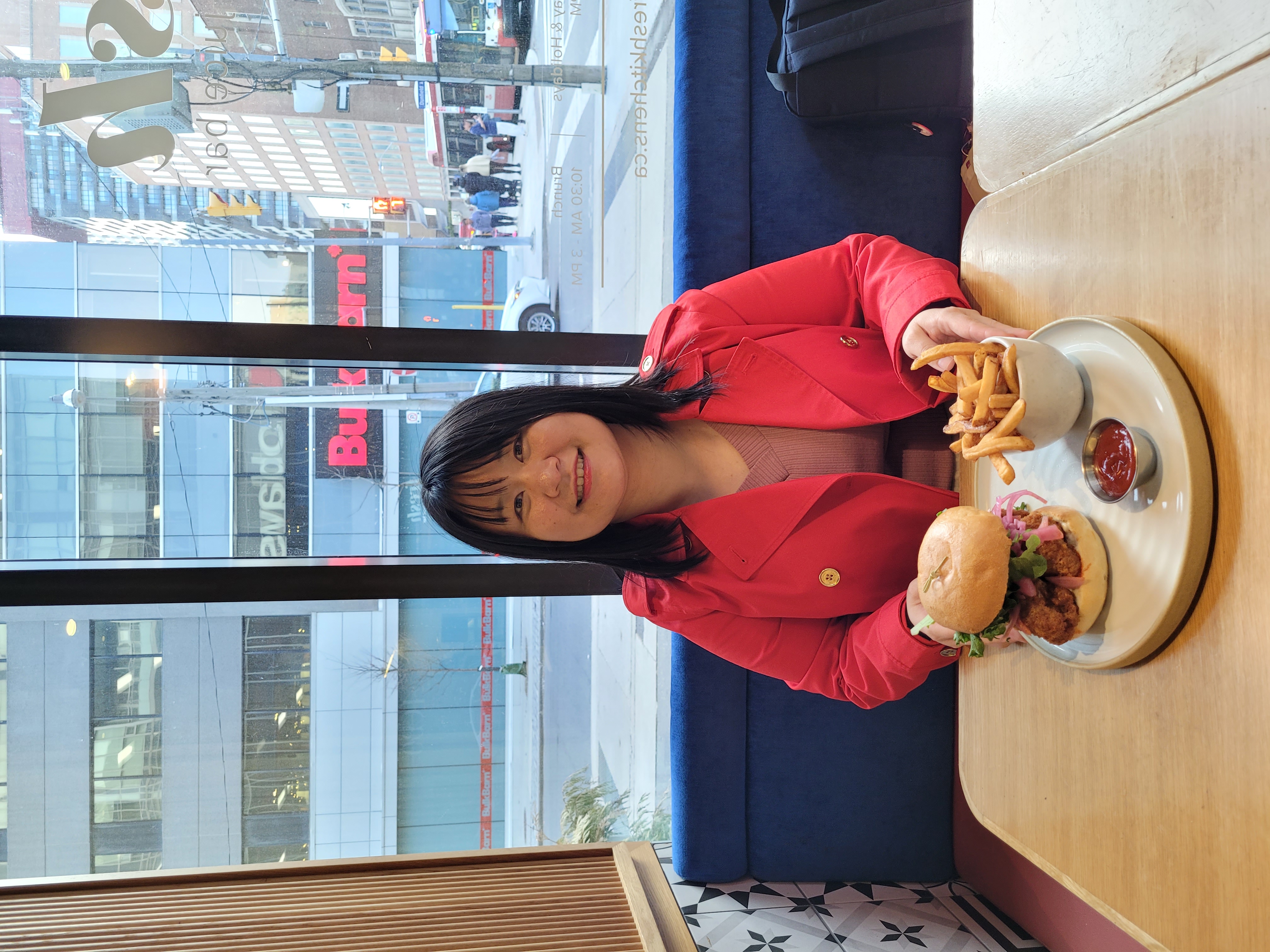 Abby sits at a restaurant window