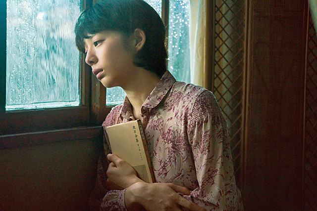 woman looking out window