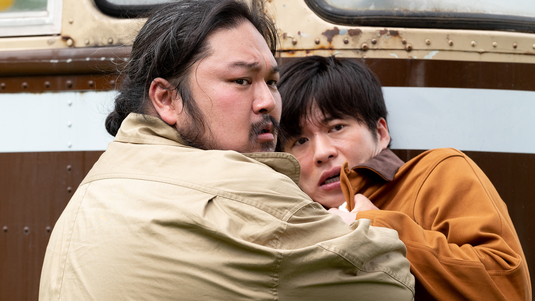 man grabbing another man by the collar