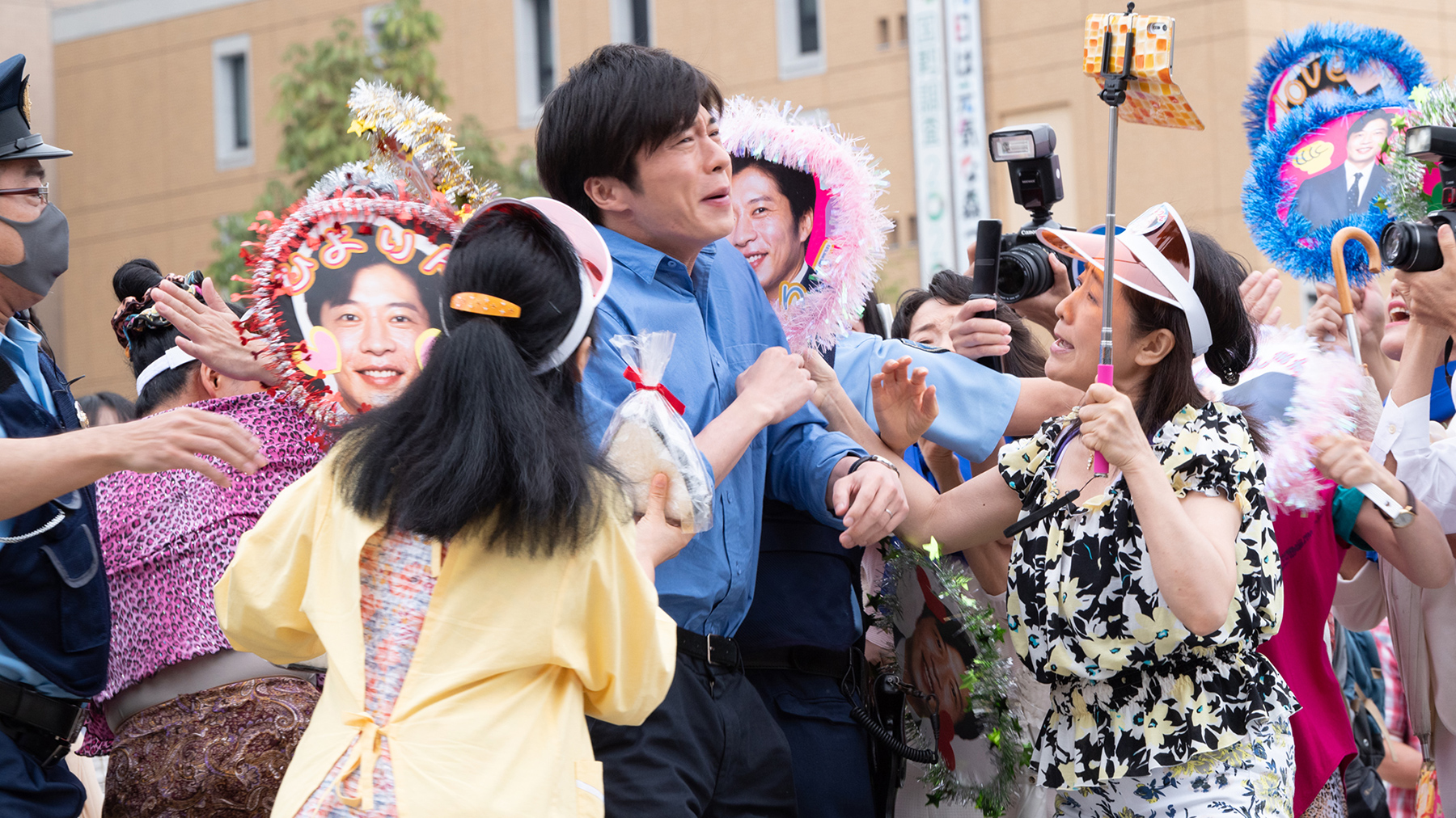 man surrounded by people with cameras