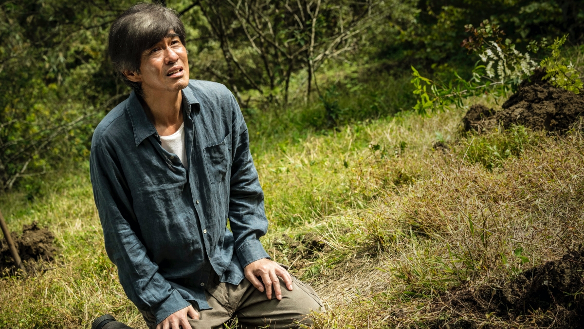 Promised Land Man kneeling on the ground