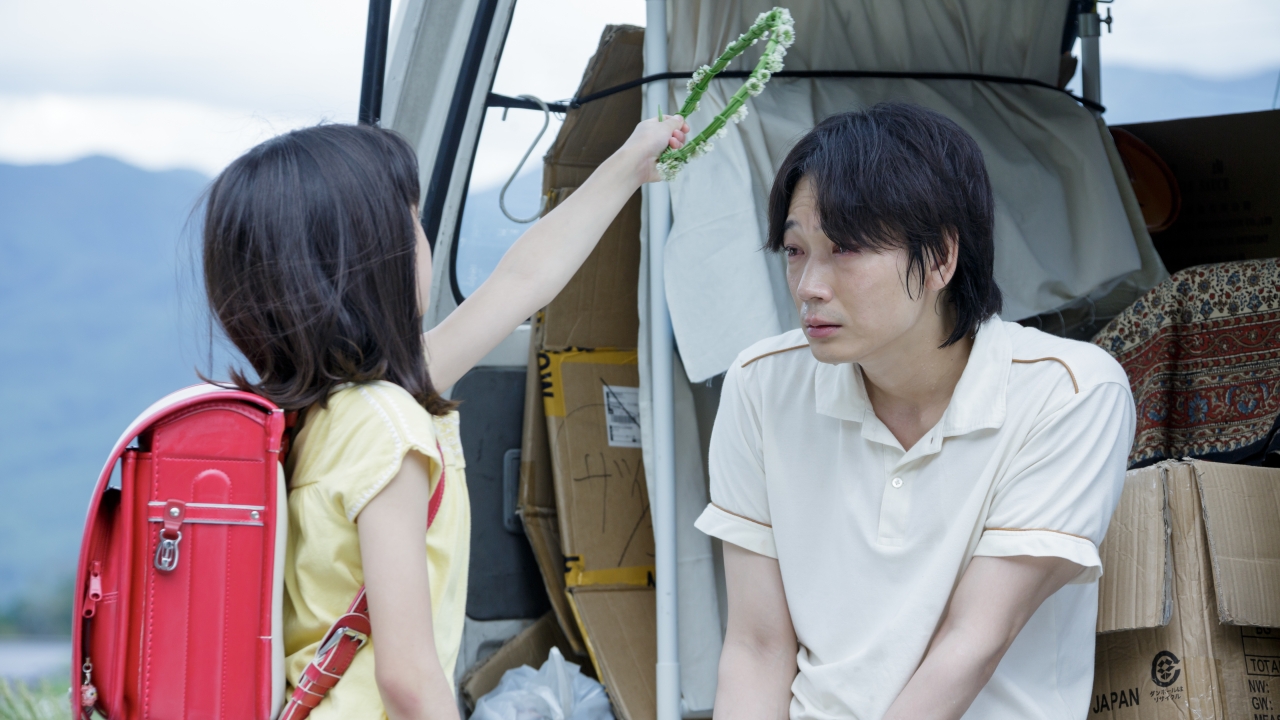Promised Land a girl giving flower wreath to a man
