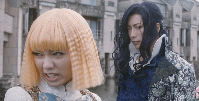 image of two women, one making a sassy face